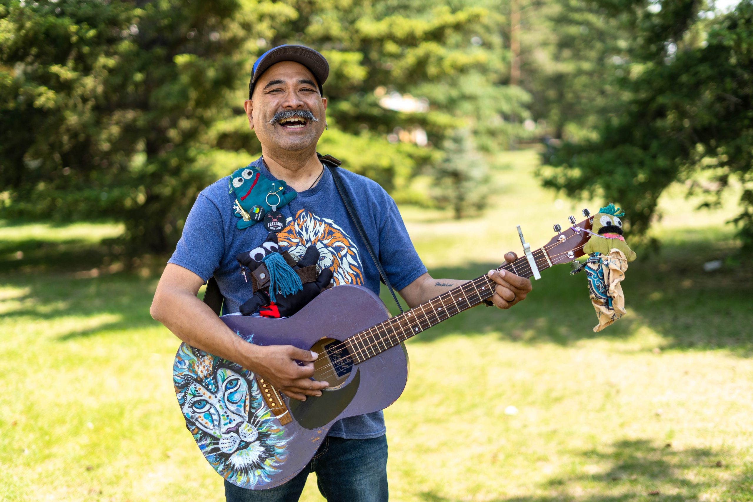 smiling Mr Rayz with guitar